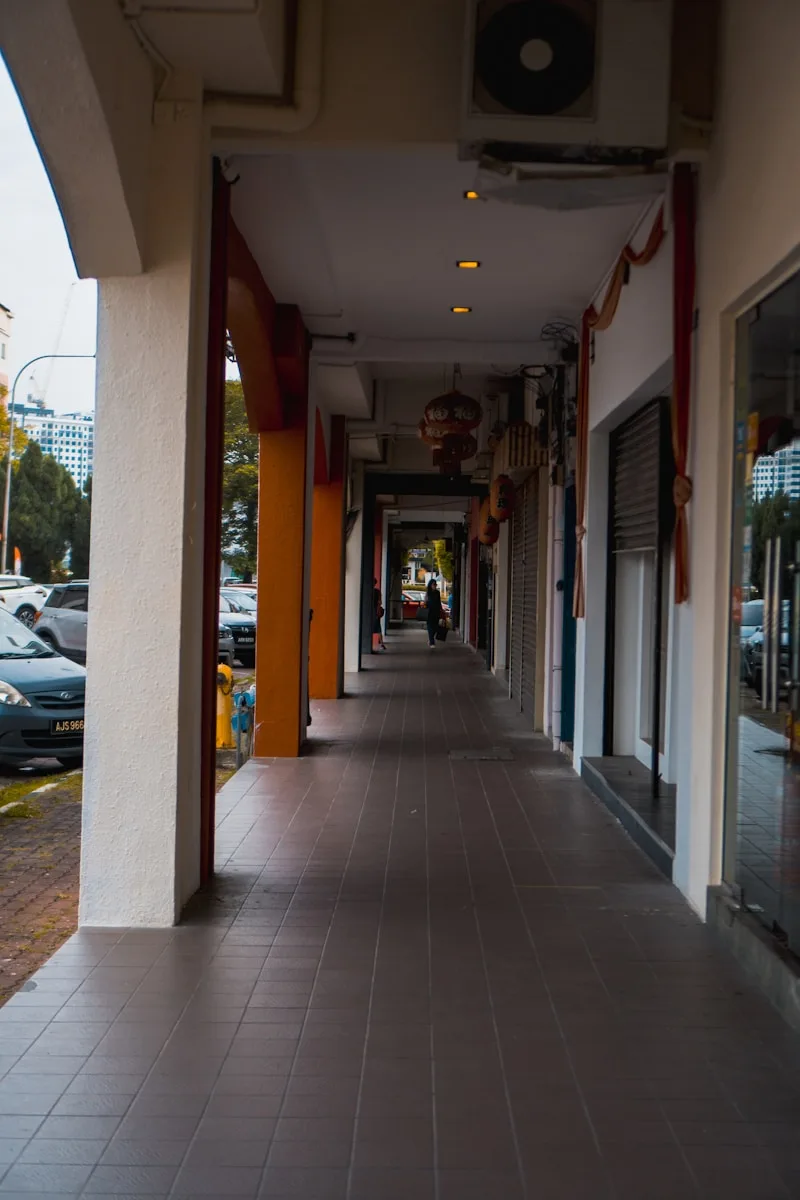 a sidewalk with a building on the side